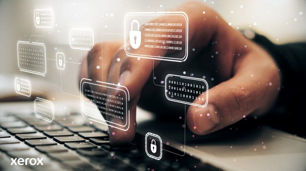 Xerox® ConnectKey® : fonctionnalités de sécurité avancées La main d'une personne tape sur un clavier d'ordinateur portable, avec des icônes de verrouillage numérique et de code binaire lumineuses superposées sur l'image, symbolisant une cybersécurité robuste et une protection des données.